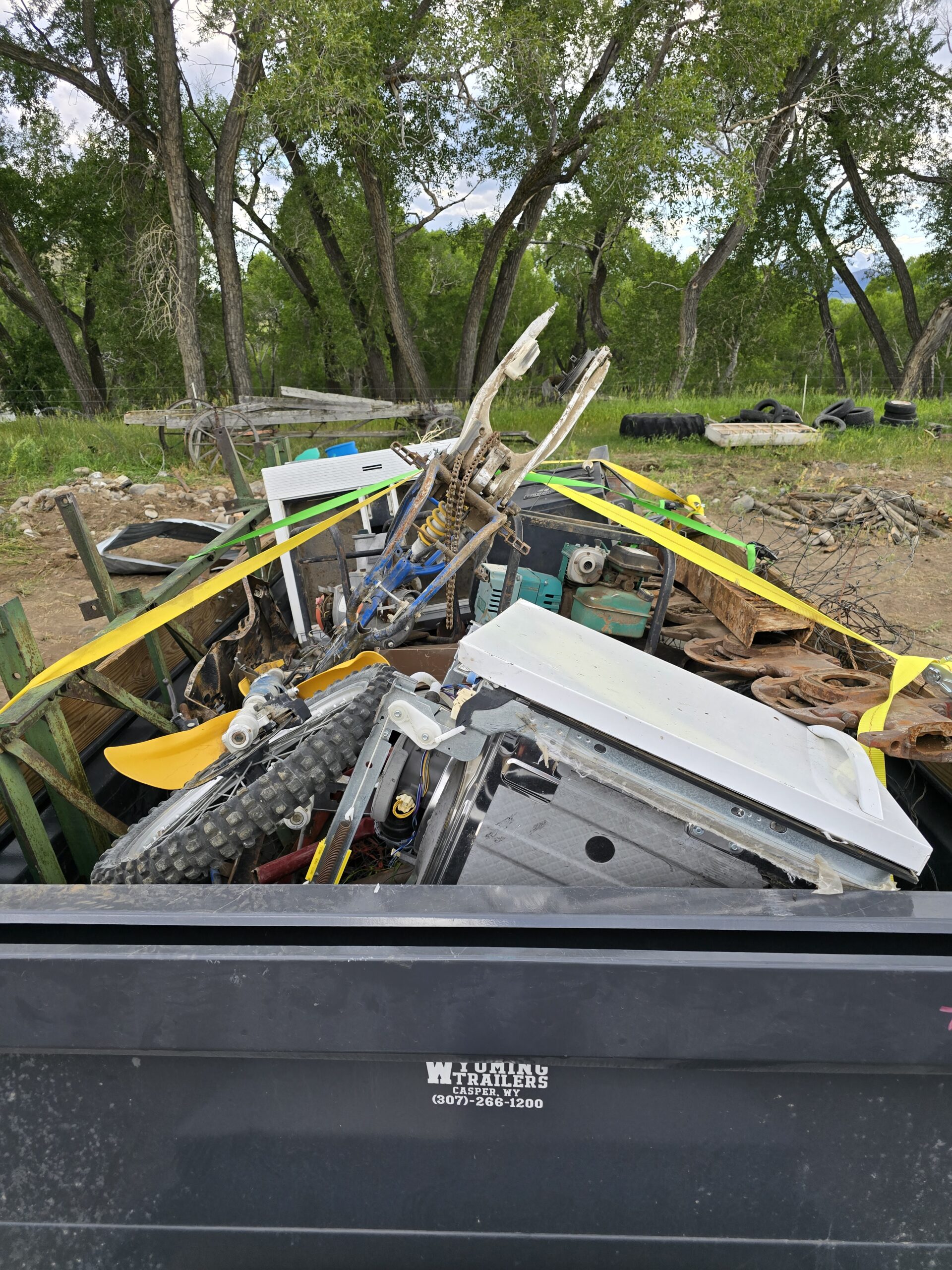 Trailer loaded with heavy metal junk from ranch in Park County, WY—commercial junk removal by Good Junk Removal.