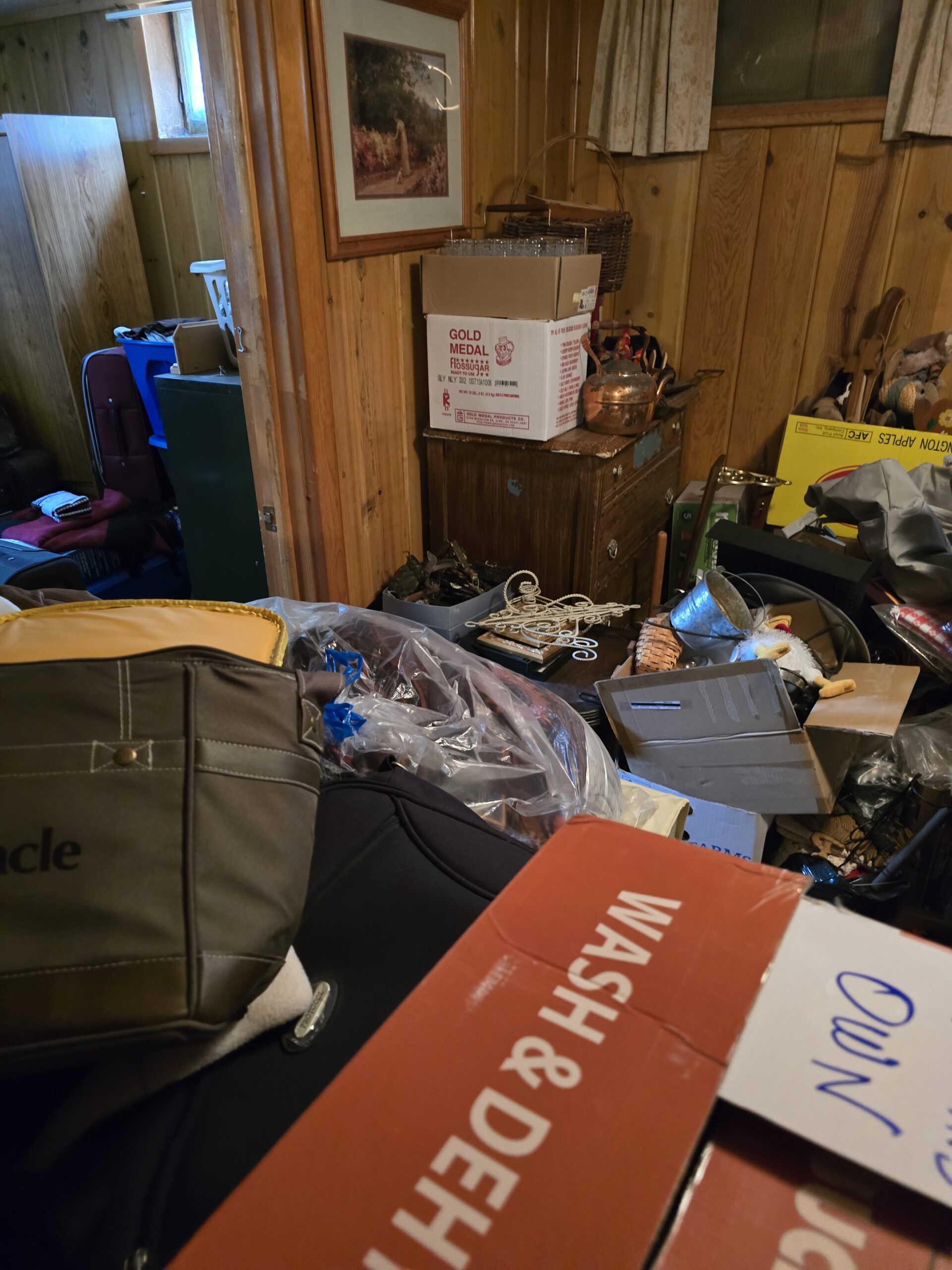 Cluttered house with clothes, boxes, and piles before estate cleanout in Park County, WY—Good Junk Removal transformation.