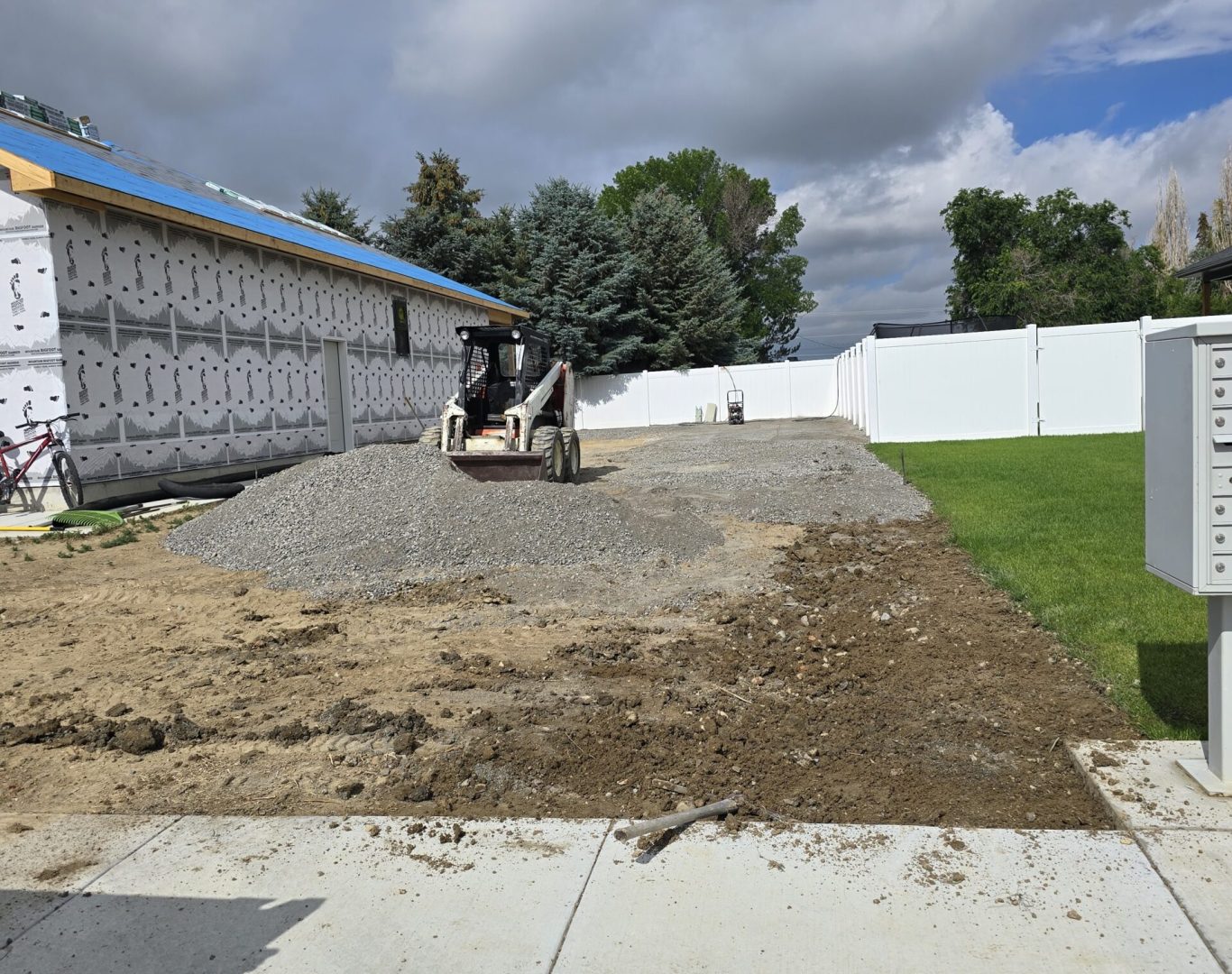 Skidsteer prepping RV pad site for light demolition in Park County, WY—Good Junk Removal team at work.