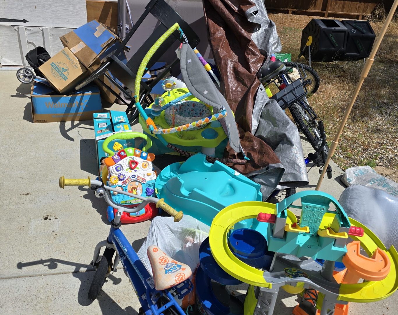 Family kid junk clutter with bikes, crib, boxes, and swing before residential junk removal in Park County, WY—Good Junk Removal.